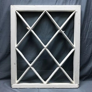 May include: White painted wood window frame with diamond-shaped glass panes. The window is approximately 30 inches wide and 40 inches tall.