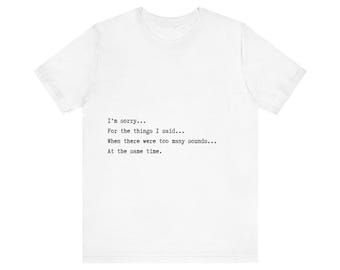 May include: White t-shirt with black text that reads "I'm sorry... For the things I said... When there were too many sounds... At the same time."