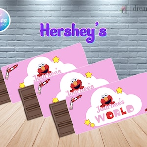 May include: Pink Hershey's candy bar wrappers with an Elmo theme. Each wrapper features Elmo, a cloud, stars, and a crayon illustration. The wrappers are paired with dark chocolate bars.