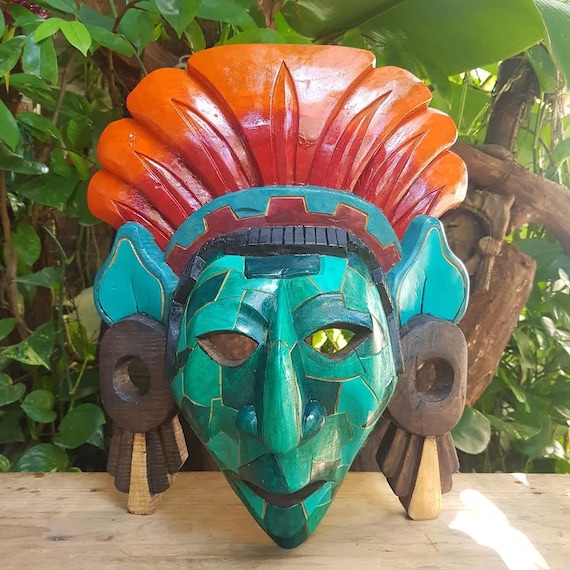 Hand-carved wooden mask inspired by Aztec iconography