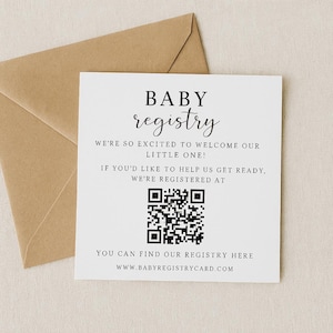 May include: A white baby registry card with black text and a QR code, placed in front of a brown envelope. The card reads "BABY registry" and includes the website www.babyregistrycard.com.