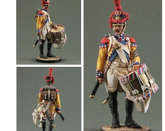 May include: A hand-painted miniature figure of a French drummer from the Napoleonic Wars. The figure is wearing a white uniform with yellow and red accents, a red and white hat with a plume, and black boots. The figure is holding a drum with red, white, and blue stripes.