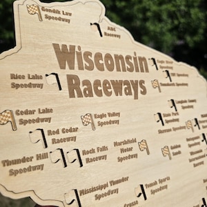 May include: Wooden sign featuring the words "Wisconsin Raceways" with various speedway names and flag graphics. The sign is light brown with dark brown text and graphics, and is shaped like the state of Wisconsin.