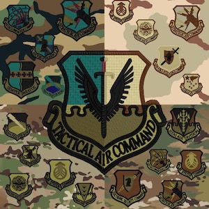 May include: A collage of various United States Air Force military patches arranged on a camouflage background. The central, largest patch features a black sword and wings with the text Tactical Air Command. Smaller patches include Strategic Air Command.