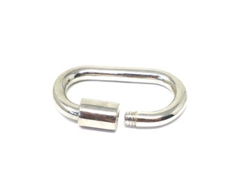 May include: A silver-toned metal clasp with a screw-on closure. The clasp is oval-shaped and has a smooth, polished finish.