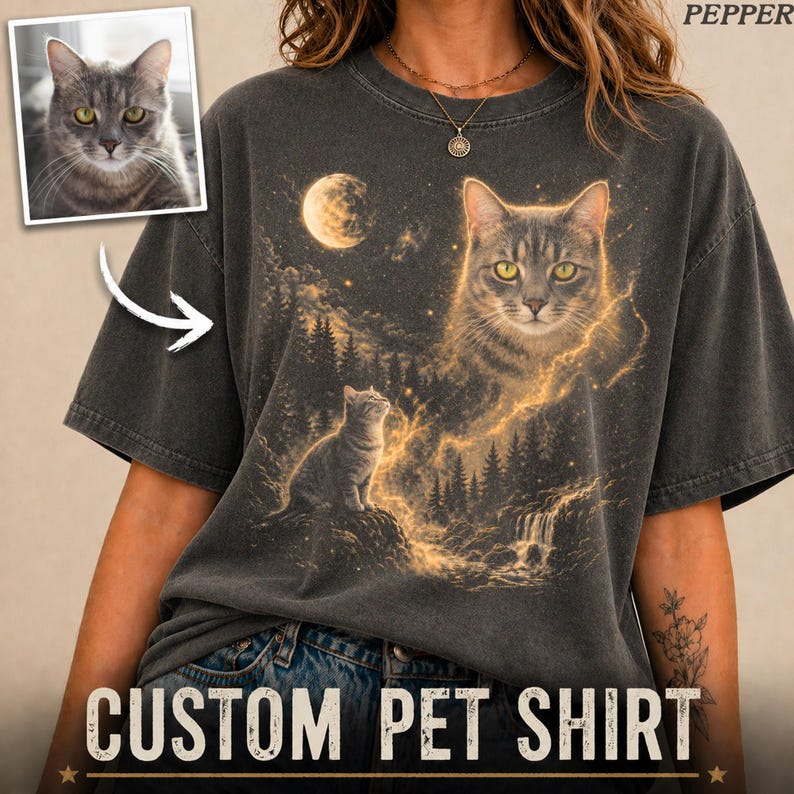 May include: Dark gray t-shirt with a custom cat portrait design. The shirt features a large cat face with a landscape of trees, a waterfall, and a moon. The text "CUSTOM PET SHIRT" is printed at the bottom.