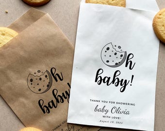 May include: White favour bag with a black and white cookie graphic and the text "Oh baby!"  Thank you for showering baby Olivia with love! August 19, 2025.