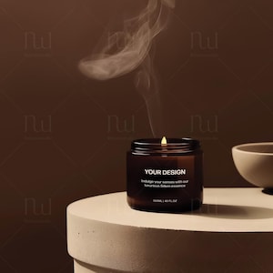 May include: A brown glass candle jar with a white label that reads "YOUR DESIGN" and "Indulge your senses with our luxurious Silken essence" and "100ML | 40 FLOZ". The candle is lit and smoke is rising from the top.