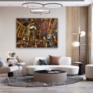 May include: A vintage-style clock tower stands tall in the middle of a bustling city street, illuminated by streetlights and Christmas decorations. The clock tower is surrounded by buildings and people walking by. The scene is captured in a warm, inviting light.