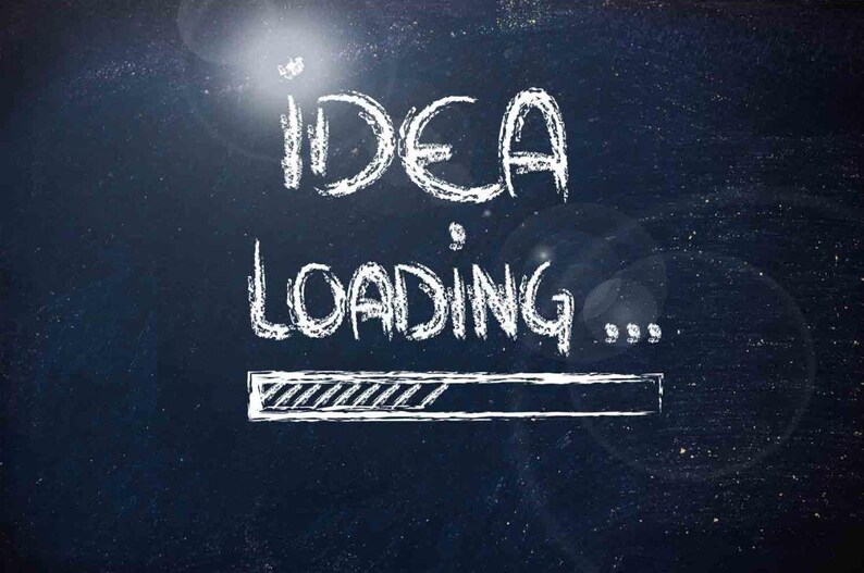 May include: A white chalk drawing on a dark blue chalkboard with the text "IDEA LOADING..." and a progress bar underneath.