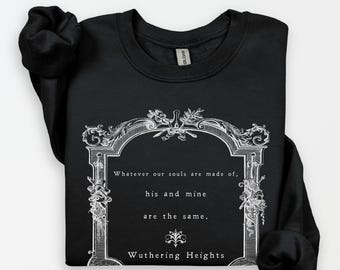 May include: A black crewneck sweatshirt featuring a white graphic print of an ornate rectangular frame. Inside the frame is the text: Whatever our souls are made of, his and mine are the same. Wuthering Heights, with a small decorative flourish.