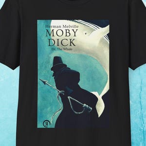 May include: Black t-shirt featuring the cover art of Herman Melville's novel, Moby Dick. The design includes the title, author's name, and a silhouette of a man with a harpoon, set against a blue and white background.