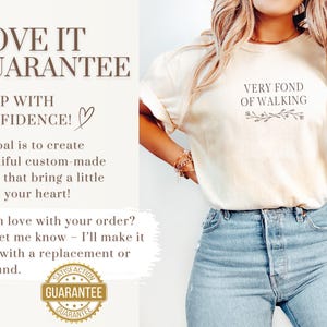 May include: Ivory-colored t-shirt with the text "VERY FOND OF WALKING" and a floral design. The image also includes text about a guarantee and the color "IVORY". The model is wearing blue jeans.