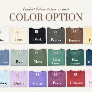 May include: A display of Comfort Colors unisex t-shirts in various colors, including white, black, and blue. The shirts are neatly folded, showcasing a range of hues like "Espresso," "Moss," and "Blossom." The text "COLOR OPTION" is displayed above the shirts.
