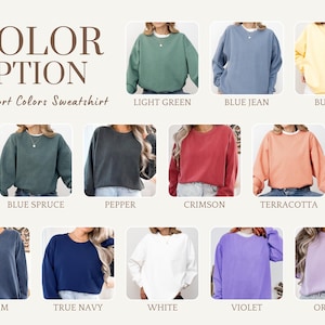 May include: A selection of Comfort Colors sweatshirts in various hues, including light green, blue jean, butter, blue spruce, pepper, crimson, terracotta, denim, true navy, white, violet, and orchid. The image displays the color options.