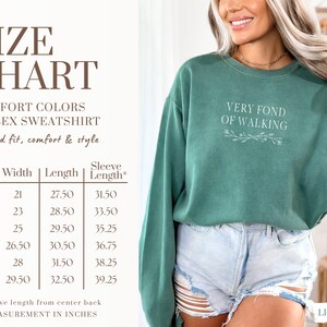 May include: Light green unisex sweatshirt with the text "VERY FOND OF WALKING". The size chart shows measurements in inches. The sweatshirt is a relaxed fit and made of comfort colors.