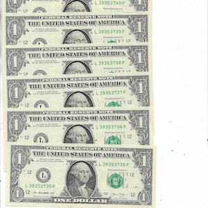 May include: Several one-dollar bills are arranged in a stack. Each bill features a portrait of George Washington and the text "The United States of America." The bills are green and black.