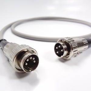May include: A gray cable with two metal connectors. One connector has six pins and the other has eight pins.