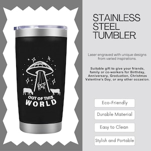 May include: A stainless steel tumbler with a black and white design featuring a UFO with cows on a swing set. The text "Out of this world" is printed on the tumbler.