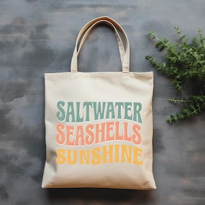 Saltwater Seashells Sunshine Tote Bag – Retro Coastal Canvas Bag with Beach Quote, Summer Gift for Her, Ocean Vibes Travel Tote