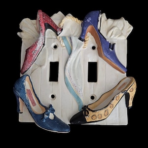 May include: A set of three ceramic mugs with a speckled, matte finish. The mugs are in shades of cream, light gray, and dark gray. Each mug has a simple, minimalist design, perfect for coffee or tea.