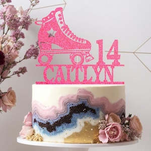 May include: Pink glitter roller skate cake topper with the name Caitlyn and the number 14.