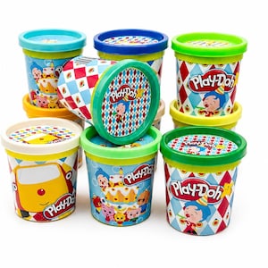 May include: A collection of Play-Doh containers with colorful lids and decorative patterns. The containers feature cartoon characters and the Play-Doh logo. The lids are blue, green, and yellow. The containers are cylindrical.