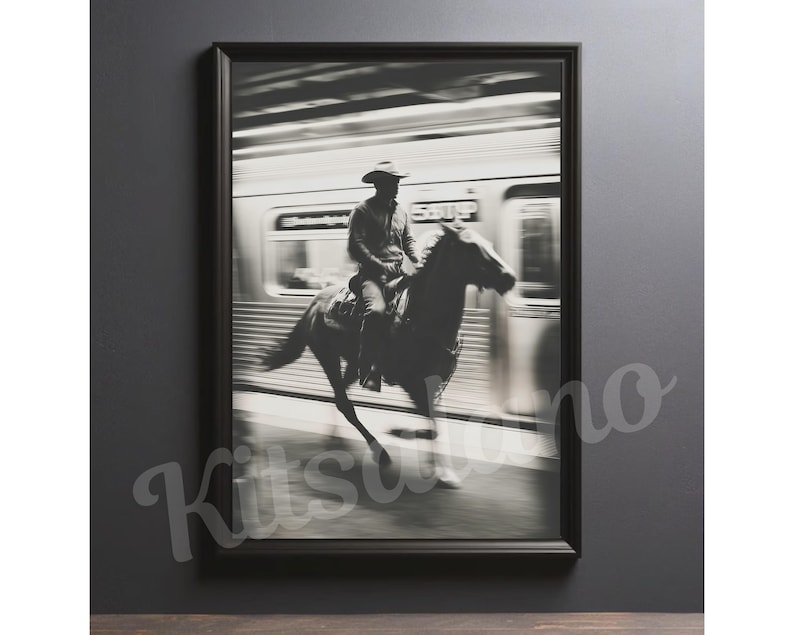 May include: Black and white framed print of a cowboy riding a horse in a subway station. The image is a study in contrasts, with the cowboy and horse in sharp focus against the blurred background of a passing train.