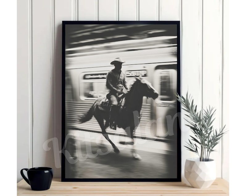 May include: Black and white framed print depicting a cowboy on horseback riding past a subway train. The image is a high-contrast photograph with motion blur, creating a dynamic and artistic effect. The word "SUBWAY" is visible on the train.