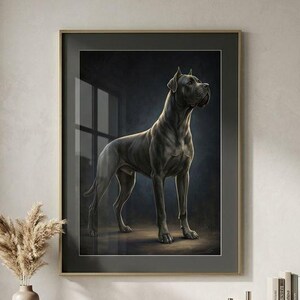 May include: A framed wall art print featuring a dark-coated Great Dane standing in profile against a deep, moody background. The artwork is encased in a thin, dark frame and is displayed above a light-toned wooden sideboard with sliding doors.