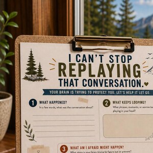 May include: A cork clipboard holding a printed mental health worksheet titled I CAN'T STOP REPLAYING THAT CONVERSATION. The document features seven numbered sections with prompts, checkboxes, and nature-themed illustrations like pine trees and mountains.