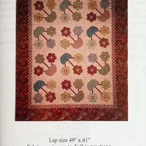 May include: A quilt pattern called "Flower Pots" with a pink background and a variety of coloured flowers and pots. The quilt is 49 inches by 61 inches. The pattern includes full instructions, paper hexagons, and templates.