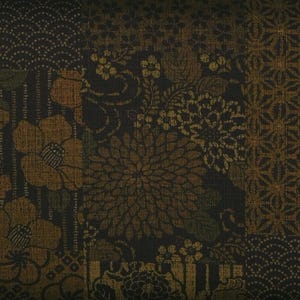 Puede incluir: Un textil estampado con un fondo oscuro, que presenta un diseño de patchwork de elementos florales y geométricos en tonos marrón, dorado y verde. El diseño incorpora grandes flores estilizadas, pequeñas flores y motivos ondulados, creando una superficie texturizada.