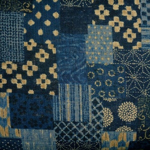 May include: A blue and beige fabric with a patchwork design. The fabric is made of a variety of different patterns, including dots, stripes, and flowers.
