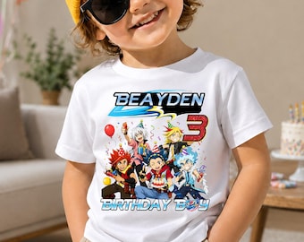 May include: A white short-sleeve t-shirt featuring a graphic print of five anime characters wearing party hats, the name "BEAYDEN" in blue and black text, a large red number "3", and the words "BIRTHDAY BOY" in blue and white lettering.