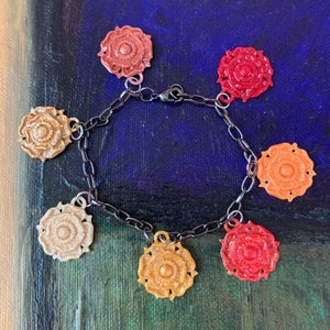 Tudor Rose charm bracelet in red and gold colors
