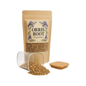 May include: A kraft paper bag of Orris Root (Iris germanica) with a clear window, a glass container, and a wooden lid. The bag features a label with purple iris illustrations. The contents of the bag and container are small, light brown pieces of the root.