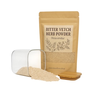 May include: A brown paper bag with a label that reads "Bitter Vetch Herb Powder (Vicia ervilia)". The bag is filled with a light brown powder. A glass jar with a wooden lid is partially filled with the powder, and some of the powder has spilled out of the jar.