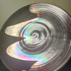 May include: A set of three ceramic nesting bowls in shades of blue, green, and white. The bowls feature a speckled glaze and a simple, modern design. The largest bowl measures approximately 6 inches in diameter.