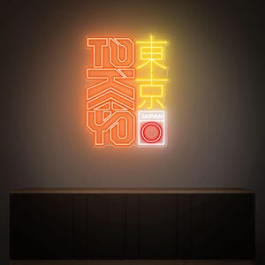 May include: Neon sign with the word "TOKYO" in orange and yellow, with Japanese characters and a red and white circle, representing the Japanese flag. The sign is mounted on a dark brown cabinet.
