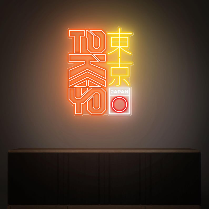 May include: Neon sign with the word "TOKYO" in orange and yellow, with Japanese characters and a red and white circle, representing the Japanese flag. The sign is mounted on a dark brown cabinet.