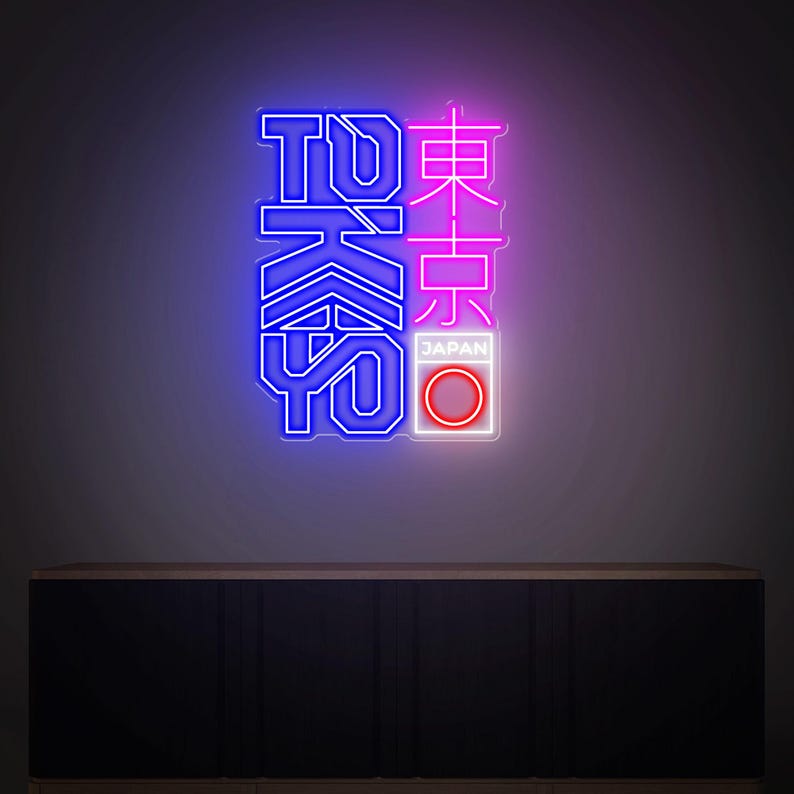 May include: Neon sign with the word "TOKYO" in blue and Japanese characters in pink. The sign includes a white rectangle with a red circle and the word "JAPAN". The sign is mounted on a dark wall.