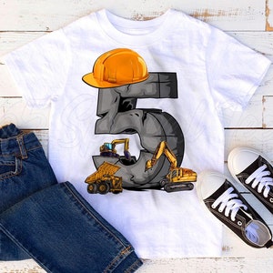 May include: White t-shirt with a graphic of the number 5, designed as a stone structure with construction vehicles. The number is topped with an orange construction helmet. Blue jeans and black canvas sneakers complete the outfit.