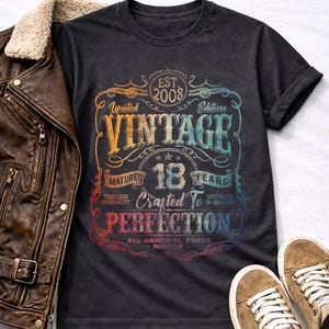 May include: A white ceramic mug with a black handle and the text "But First, Coffee" in a black, bold font. The mug is sitting on a wooden surface. The mug is approximately 4 inches tall.