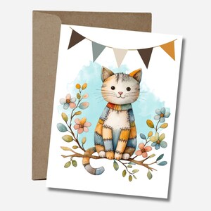 May include: A watercolour greeting card showing a patchwork cat on a branch with flowers. The cat has a blue, orange, and yellow patchwork design. A banner with brown, grey, and orange triangles is above the cat.
