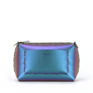May include: Iridescent clutch purse with a zipper closure and a small silver-tone ring. The bag has a rectangular shape with a stitched border and a rectangular design on the front. The color shifts between blue, purple, and green.