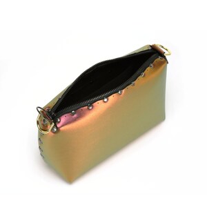 May include: A small iridescent green, orange, and pink handbag with a black zipper and silver studs. The bag has a gold metal handle.
