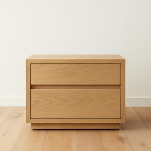 May include: A light wood two-drawer nightstand with a simple design. The nightstand has a rectangular shape and sits on a slightly raised base.