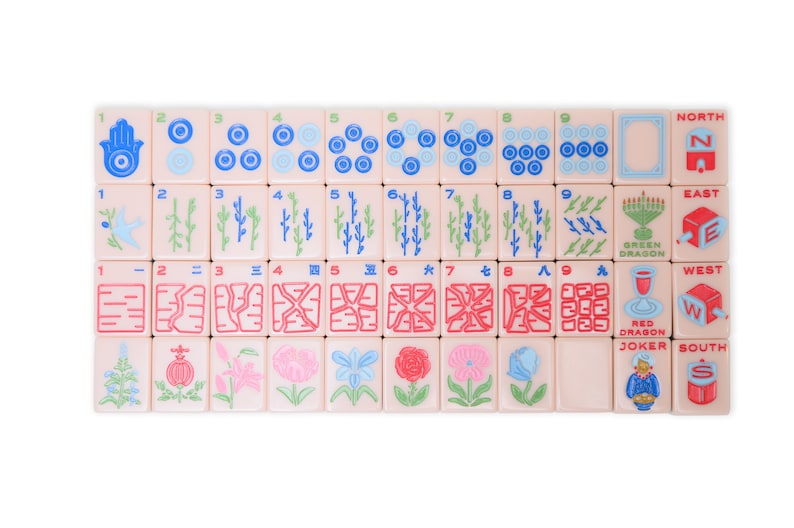 May include: A set of 36 mahjong tiles with various symbols and numbers. The tiles are pink with blue, green, and red accents. The tiles are arranged in four rows of nine tiles each. The tiles include numbers 1 through 9, bamboo, circles, characters, wind tiles, dragon tiles, and a joker tile.