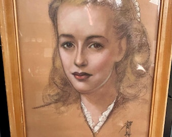 May include: A framed portrait of a woman with blonde hair and a pearl hair accessory. The artwork is a pastel drawing with a sepia-toned background and a light brown wooden frame. The woman is wearing a white lace collar and has red lipstick.